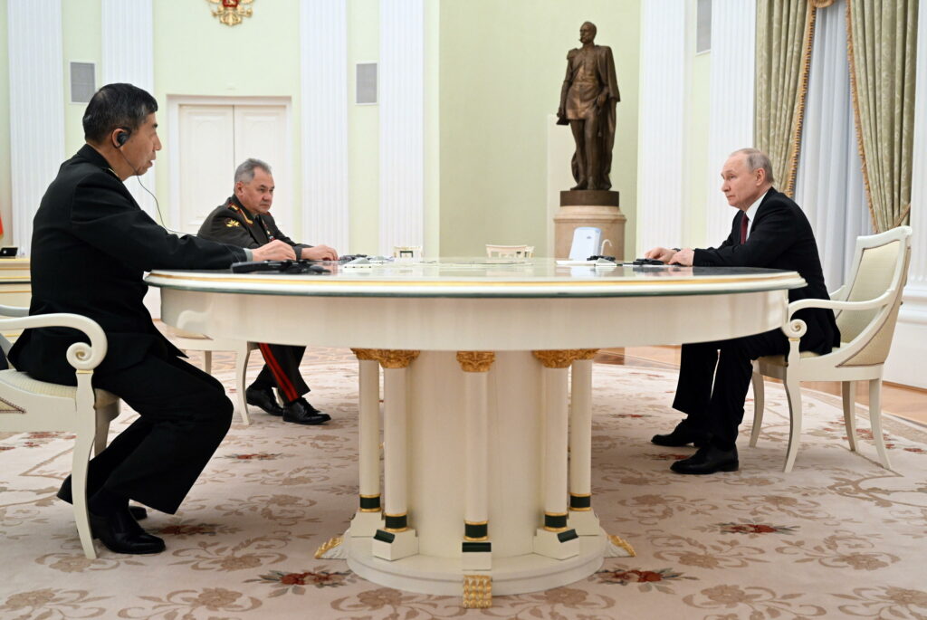 Russian President Vladimir Putin (R), Chinese Defence Minister Li Shangfu (L) and Russian Defence Minister Sergei Shoigu